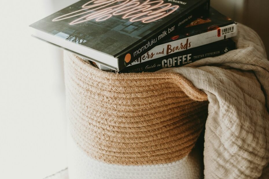 a stack of books sitting on top of a coffee cup