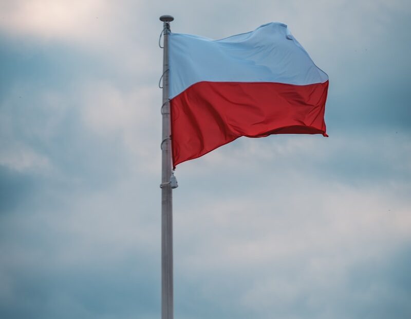 blue and white flag under white clouds